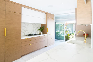 Inspiration for a mid-sized contemporary galley cork floor and white floor kitchen remodel in Los Angeles with an undermount sink, flat-panel cabinets, medium tone wood cabinets, marble countertops, white backsplash, marble backsplash, paneled appliances, no island and white countertops