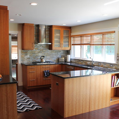 Mid-sized trendy u-shaped dark wood floor eat-in kitchen photo in Newark with a single-bowl sink, flat-panel cabinets, medium tone wood cabinets, granite countertops, gray backsplash, stone tile backsplash, stainless steel appliances and a peninsula