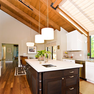 Design ideas for a large contemporary u-shaped separate kitchen in San Francisco with an undermount sink, louvered cabinets, dark wood cabinets, quartzite benchtops, grey splashback, porcelain splashback, stainless steel appliances and medium hardwood floors.