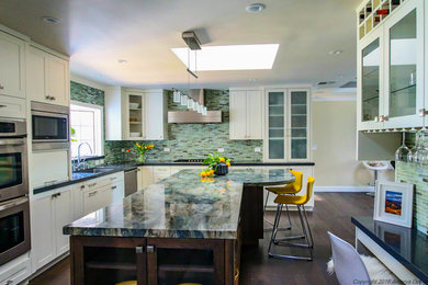 Large contemporary l-shaped kitchen/diner in San Francisco with a submerged sink, shaker cabinets, white cabinets, onyx worktops, multi-coloured splashback, mosaic tiled splashback, stainless steel appliances, dark hardwood flooring, an island, brown floors and multicoloured worktops.