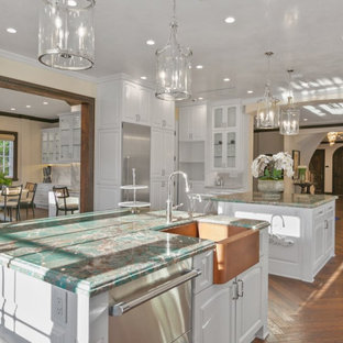 Design ideas for a large transitional u-shaped separate kitchen in Los Angeles with a farmhouse sink, shaker cabinets, white cabinets, marble benchtops, beige splashback, marble splashback, stainless steel appliances, dark hardwood floors, multiple islands, multi-coloured floor and turquoise benchtop.