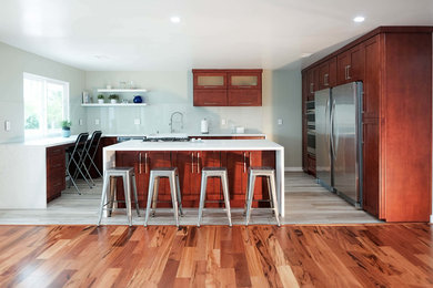 Inspiration for a huge u-shaped light wood floor and beige floor eat-in kitchen remodel in Orange County with a single-bowl sink, shaker cabinets, white cabinets, quartz countertops, white backsplash, glass tile backsplash, stainless steel appliances, an island and white countertops