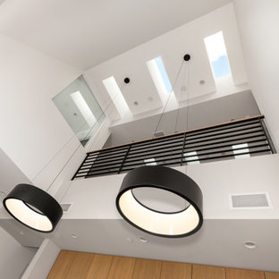 Modern kitchen designs - Minimalist light wood floor and beige floor kitchen photo in Los Angeles with a single-bowl sink, flat-panel cabinets, light wood cabinets, quartzite countertops, white backsplash, porcelain backsplash, stainless steel appliances, an island and gray countertops