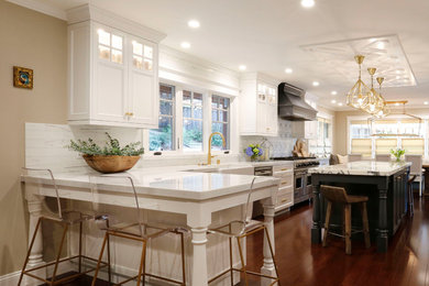 Example of a large transitional l-shaped bamboo floor and brown floor eat-in kitchen design in San Francisco with a farmhouse sink, shaker cabinets, gray cabinets, marble countertops, white backsplash, marble backsplash, stainless steel appliances and two islands