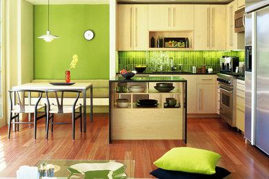 Eat-in kitchen - modern l-shaped eat-in kitchen idea in San Francisco with stainless steel appliances, an undermount sink, flat-panel cabinets, light wood cabinets and green backsplash