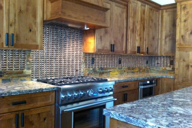 Inspiration for a mid-sized rustic medium tone wood floor kitchen remodel in Sacramento with quartz countertops, glass tile backsplash, stainless steel appliances and an island
