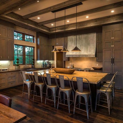 Example of a mountain style l-shaped dark wood floor eat-in kitchen design in Sacramento with shaker cabinets, dark wood cabinets, beige backsplash, paneled appliances and an island