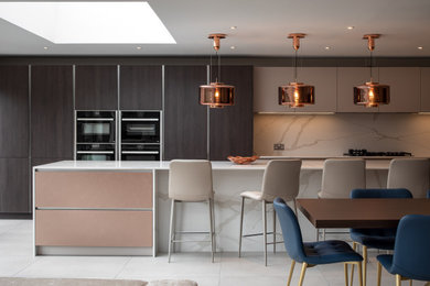Design ideas for a large contemporary l-shaped open plan kitchen in West Midlands with a double-bowl sink, flat-panel cabinets, beige cabinets, marble worktops, white splashback, marble splashback, integrated appliances, porcelain flooring, an island, grey floors, white worktops and a coffered ceiling.