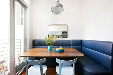 Mid-sized minimalist medium tone wood floor kitchen/dining room combo photo in New York