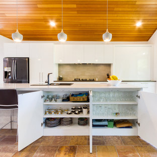 Design ideas for a large contemporary galley eat-in kitchen in Melbourne with a drop-in sink, flat-panel cabinets, white cabinets, quartz benchtops, stainless steel appliances, porcelain floors, with island, brown floor, grey benchtop and brown splashback.