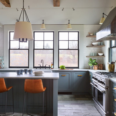 Enclosed kitchen - mid-sized transitional l-shaped slate floor and gray floor enclosed kitchen idea in Boston with a farmhouse sink, shaker cabinets, blue cabinets, quartzite countertops, white backsplash, subway tile backsplash, stainless steel appliances, an island and white countertops