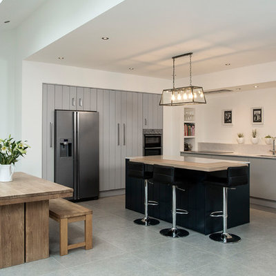 Inspiration for a large contemporary l-shaped eat-in kitchen remodel in Dublin with an undermount sink, flat-panel cabinets, gray cabinets, stainless steel appliances and a peninsula