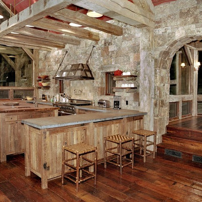 Kitchen - rustic kitchen idea in Denver with wood countertops, stainless steel appliances and stone tile backsplash