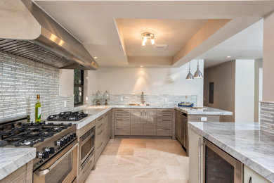 Example of a large transitional galley ceramic tile and beige floor kitchen pantry design in Miami with an undermount sink, flat-panel cabinets, gray cabinets, gray backsplash, matchstick tile backsplash, stainless steel appliances and a peninsula