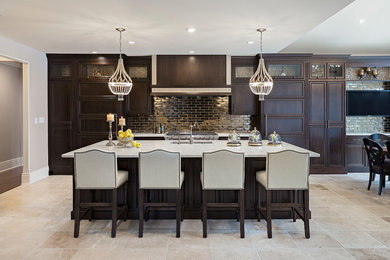 Large traditional kitchen in Other with a double-bowl sink, recessed-panel cabinets, dark wood cabinets, quartz worktops, metallic splashback, metro tiled splashback, stainless steel appliances, travertine flooring and an island.