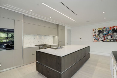 Example of a mid-sized minimalist galley light wood floor and beige floor open concept kitchen design in DC Metro with an undermount sink, flat-panel cabinets, gray cabinets, quartz countertops, white backsplash, marble backsplash and an island