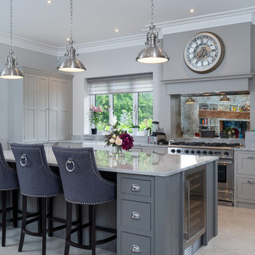 Luxurious grey hand painted kitchen with large kitchen island and white worktops