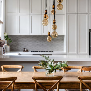 Inspiration for a transitional u-shaped eat-in kitchen in Perth with shaker cabinets, white cabinets, grey splashback, stainless steel appliances, a peninsula and white benchtop.
