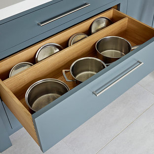 Inspiration for a large contemporary l-shaped eat-in kitchen in Kent with a double-bowl sink, flat-panel cabinets, white cabinets, solid surface benchtops, glass tile splashback, stainless steel appliances, ceramic floors and with island.