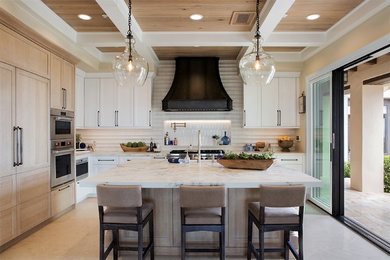 Example of a large transitional l-shaped limestone floor and beige floor kitchen design in Denver with recessed-panel cabinets, white cabinets, quartz countertops, white backsplash, ceramic backsplash, paneled appliances, an island and white countertops