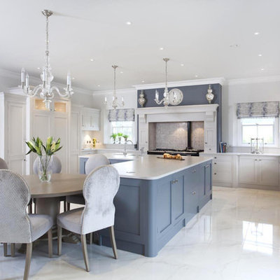 Eat-in kitchen - large traditional u-shaped porcelain tile eat-in kitchen idea in Other with a farmhouse sink, shaker cabinets, gray cabinets, quartzite countertops, multicolored backsplash, mosaic tile backsplash, stainless steel appliances and an island