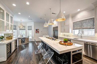 Eat-in kitchen - large contemporary galley dark wood floor eat-in kitchen idea in Houston with an integrated sink, shaker cabinets, white cabinets, marble countertops, white backsplash, stone slab backsplash, stainless steel appliances and an island