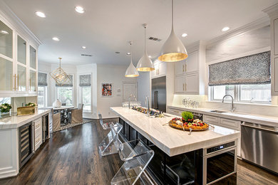 Inspiration for a large contemporary galley kitchen/diner in Houston with an integrated sink, shaker cabinets, white cabinets, marble worktops, white splashback, stone slab splashback, stainless steel appliances, dark hardwood flooring and an island.