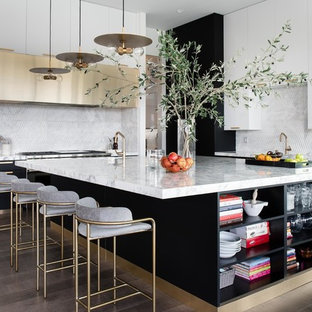 Large contemporary kitchen ideas - Large trendy dark wood floor and brown floor kitchen photo in Las Vegas with flat-panel cabinets, an island, white cabinets, marble countertops, white backsplash and white countertops