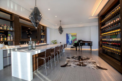Example of a large trendy galley porcelain tile and gray floor open concept kitchen design in Los Angeles with flat-panel cabinets, dark wood cabinets, quartz countertops, an island and white countertops
