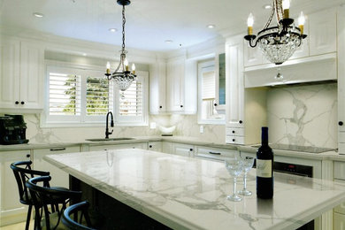 Large minimalist l-shaped porcelain tile and beige floor eat-in kitchen photo in Miami with a double-bowl sink, raised-panel cabinets, white cabinets, black appliances and an island