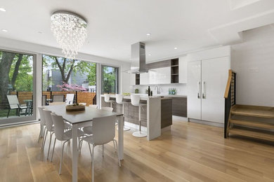 Inspiration for a mid-sized contemporary galley beige floor and light wood floor open concept kitchen remodel in New York with flat-panel cabinets, dark wood cabinets, stainless steel appliances, an island, an undermount sink, quartz countertops, white backsplash and glass sheet backsplash