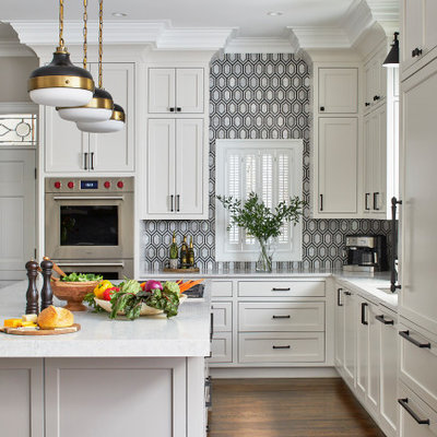 Kitchen - large modern l-shaped dark wood floor kitchen idea in Atlanta with a single-bowl sink, white cabinets, quartz countertops, black backsplash, mosaic tile backsplash, paneled appliances, an island, gray countertops and beaded inset cabinets
