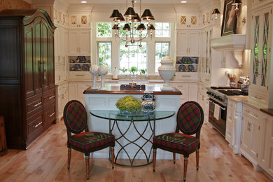 Large elegant u-shaped light wood floor eat-in kitchen photo in Milwaukee with a farmhouse sink, beaded inset cabinets, white cabinets, quartzite countertops, beige backsplash, stone slab backsplash, stainless steel appliances and two islands
