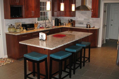 Inspiration for a large transitional l-shaped ceramic tile eat-in kitchen remodel in Philadelphia with a drop-in sink, recessed-panel cabinets, medium tone wood cabinets, granite countertops, gray backsplash, stainless steel appliances, an island and ceramic backsplash