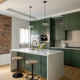 Large transitional eat-in kitchen photos - Example of a large transitional l-shaped brown floor, tray ceiling and light wood floor eat-in kitchen design in Detroit with an undermount sink, shaker cabinets, green cabinets, white backsplash, stainless steel appliances, an island, white countertops, quartz countertops and quartz backsplash