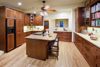 Enclosed kitchen - traditional enclosed kitchen idea in Sacramento with shaker cabinets, medium tone wood cabinets, paneled appliances and an island