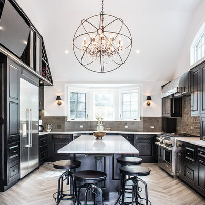 Eat-in kitchen - large transitional u-shaped porcelain tile eat-in kitchen idea in New York with black cabinets, stainless steel appliances, an island, raised-panel cabinets, an undermount sink, solid surface countertops, gray backsplash and ceramic backsplash
