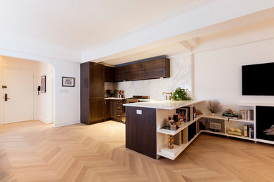 Eat-in kitchen - mid-sized contemporary l-shaped light wood floor and beige floor eat-in kitchen idea in New York with an undermount sink, recessed-panel cabinets, dark wood cabinets, marble countertops, white backsplash, marble backsplash, stainless steel appliances, no island and white countertops