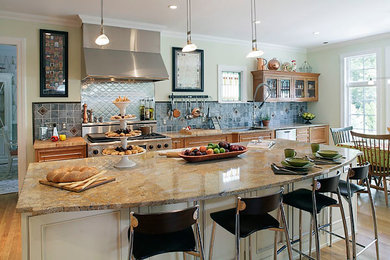 Example of a large classic l-shaped medium tone wood floor and brown floor eat-in kitchen design in New York with an undermount sink, medium tone wood cabinets, granite countertops, blue backsplash, glass tile backsplash, stainless steel appliances, recessed-panel cabinets and an island
