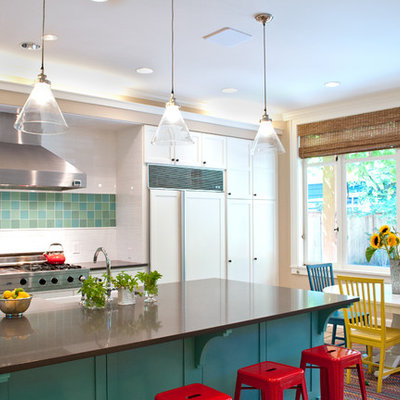 Inspiration for a large modern u-shaped terra-cotta tile and beige floor eat-in kitchen remodel in Seattle with a farmhouse sink, raised-panel cabinets, white cabinets, solid surface countertops, white backsplash, subway tile backsplash, stainless steel appliances and an island