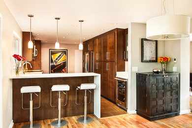 Example of a mid-sized trendy l-shaped porcelain tile and brown floor eat-in kitchen design in Seattle with an undermount sink, flat-panel cabinets, medium tone wood cabinets, quartz countertops, stainless steel appliances and a peninsula