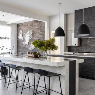Design ideas for a contemporary kitchen in Houston with flat-panel cabinets, black splashback, with island, grey floor and multi-coloured benchtop.