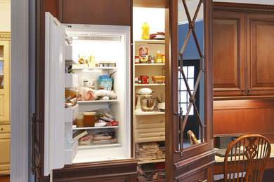 Example of a classic kitchen design in Dallas with raised-panel cabinets and dark wood cabinets