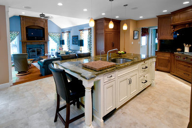 Eat-in kitchen - mid-sized traditional l-shaped limestone floor and beige floor eat-in kitchen idea in Boston with an undermount sink, shaker cabinets, dark wood cabinets, solid surface countertops, stainless steel appliances and an island