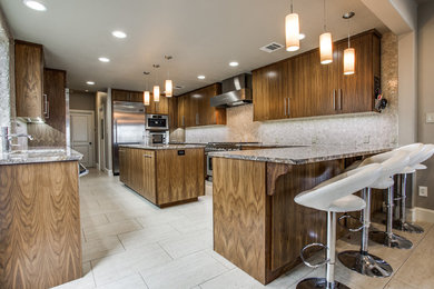 Eat-in kitchen - huge transitional galley porcelain tile eat-in kitchen idea in Dallas with an undermount sink, flat-panel cabinets, dark wood cabinets, laminate countertops, beige backsplash, stainless steel appliances and an island