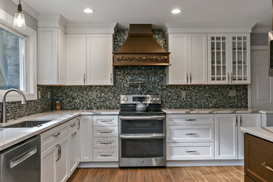 Eat-in kitchen - mid-sized transitional l-shaped medium tone wood floor and brown floor eat-in kitchen idea in New York with an undermount sink, shaker cabinets, white cabinets, multicolored backsplash, mosaic tile backsplash, stainless steel appliances, no island, multicolored countertops and marble countertops