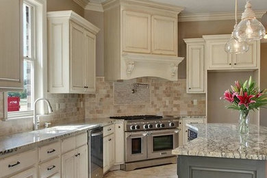 Immagine di una cucina chic di medie dimensioni con lavello sottopiano, ante con bugna sagomata, ante con finitura invecchiata e elettrodomestici in acciaio inossidabile