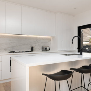 This is an example of a contemporary galley open plan kitchen in Melbourne with with island.