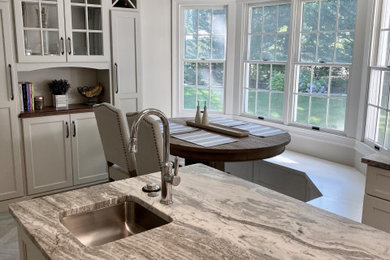 Inspiration for a mid-sized coastal gray floor enclosed kitchen remodel in New York with shaker cabinets, beige cabinets, granite countertops, blue backsplash, subway tile backsplash, an island and multicolored countertops