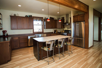 Kitchen - traditional light wood floor kitchen idea in Seattle with a farmhouse sink, shaker cabinets, red cabinets, stainless steel appliances and an island